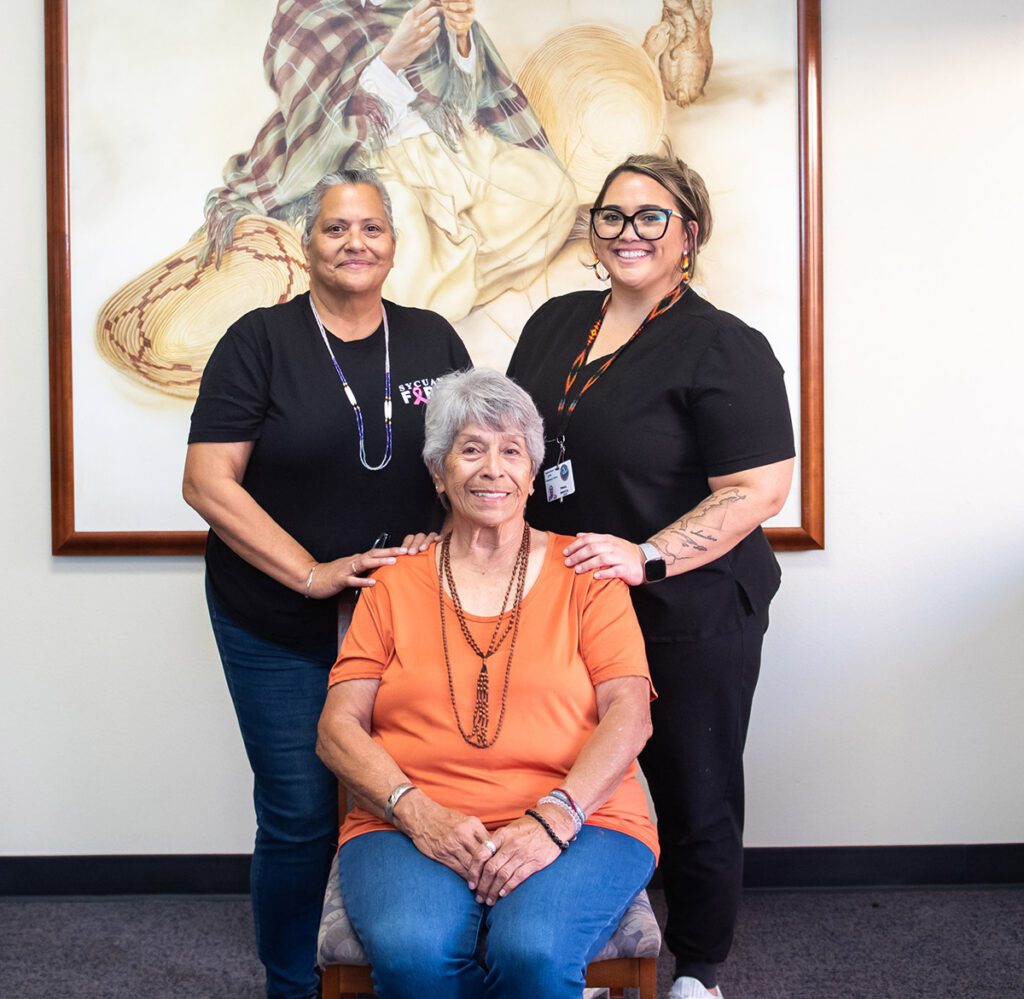 Health care workers with elderly patient.